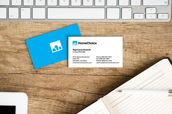 HomeChoice business card design front and back on desk with keyboard and notebook